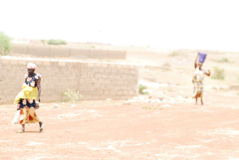 two women walking on the road
