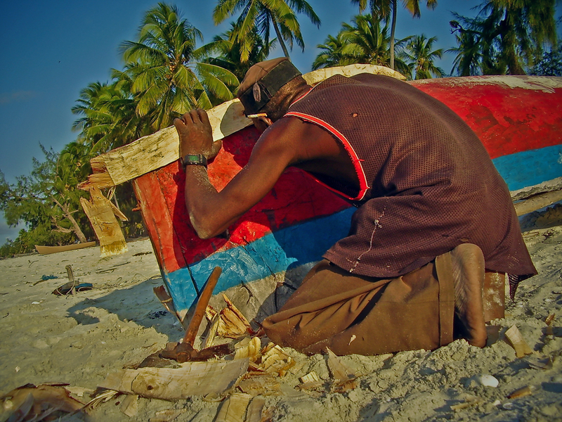 Repairing the keel of his canoe
